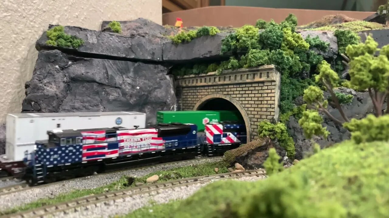 N Scale intermodal and grain train race out of the tunnel