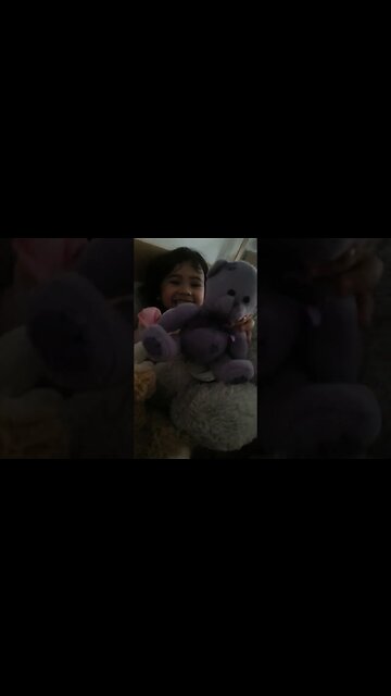 Baby Abi giggles happy surrendered by toys