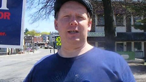 A person holding a Sign for Stephen Lynch at a polling place in Fitchburg