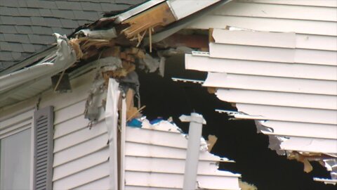 Sanitation truck crashes into bridge in Buffalo and causes damage to nearby home