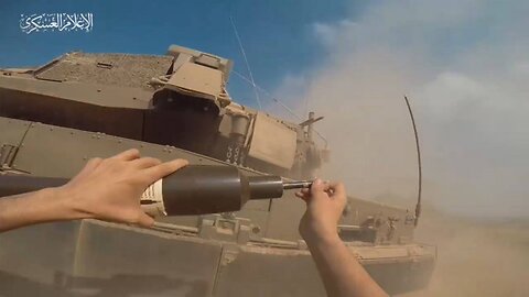 Unique footage of how a Hamas man runs up to a moving Merkava Mk4M and