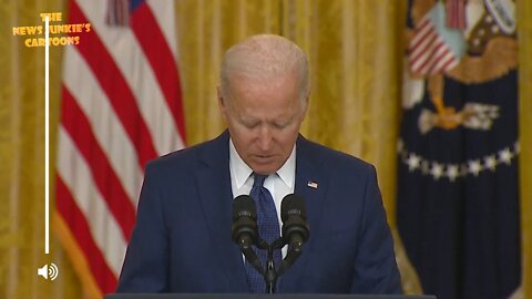 Biden seems to be checking his phone in moment of silence.