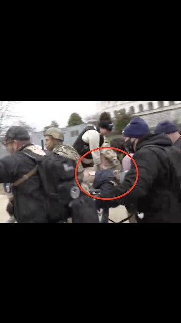 Kevin Greeson carried on a barrier while a woman tries to revive him