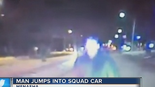 Menasha man arrested after jumping on police car