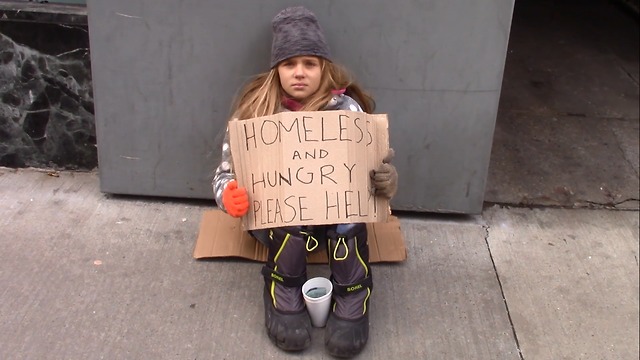 Young Homeless Girl Sits Alone Begging For Help. Pay Close Attention To Woman In Red Plaid