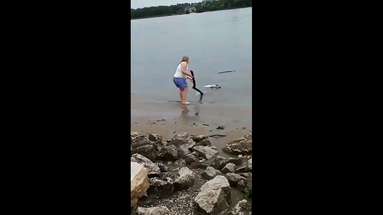 stacie plays with a dead fish