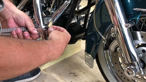 Installing foot pegs on my Harley Davidson.