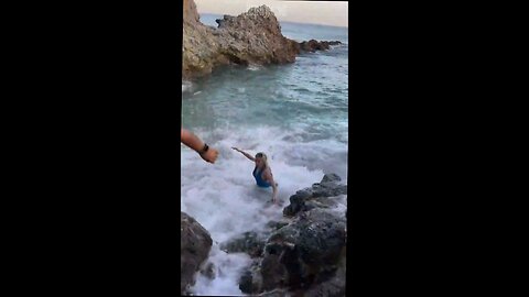 chick in photo shoot is swept off rocks and dragged away by current