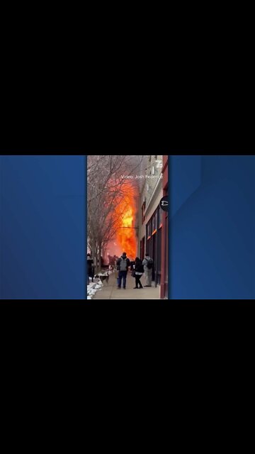 Flames shoot out the front of a building on Main Street in Buffalo