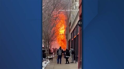 Flames shoot out the front of a building on Main Street in Buffalo