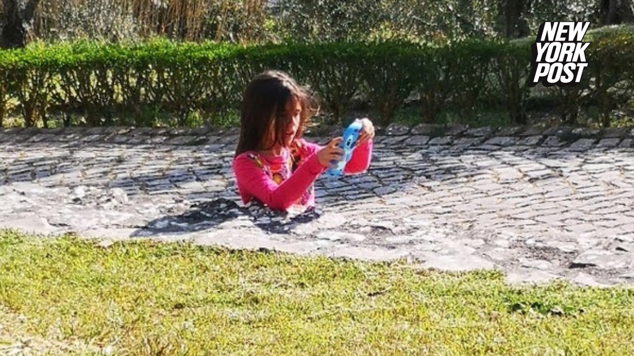 Internet baffled by photo of girl seemingly stuck in sidewalk