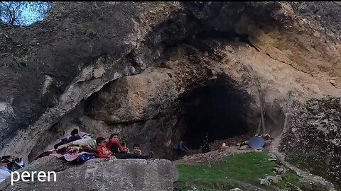 A tribal family made a shelter for the family for a while living in a cave.