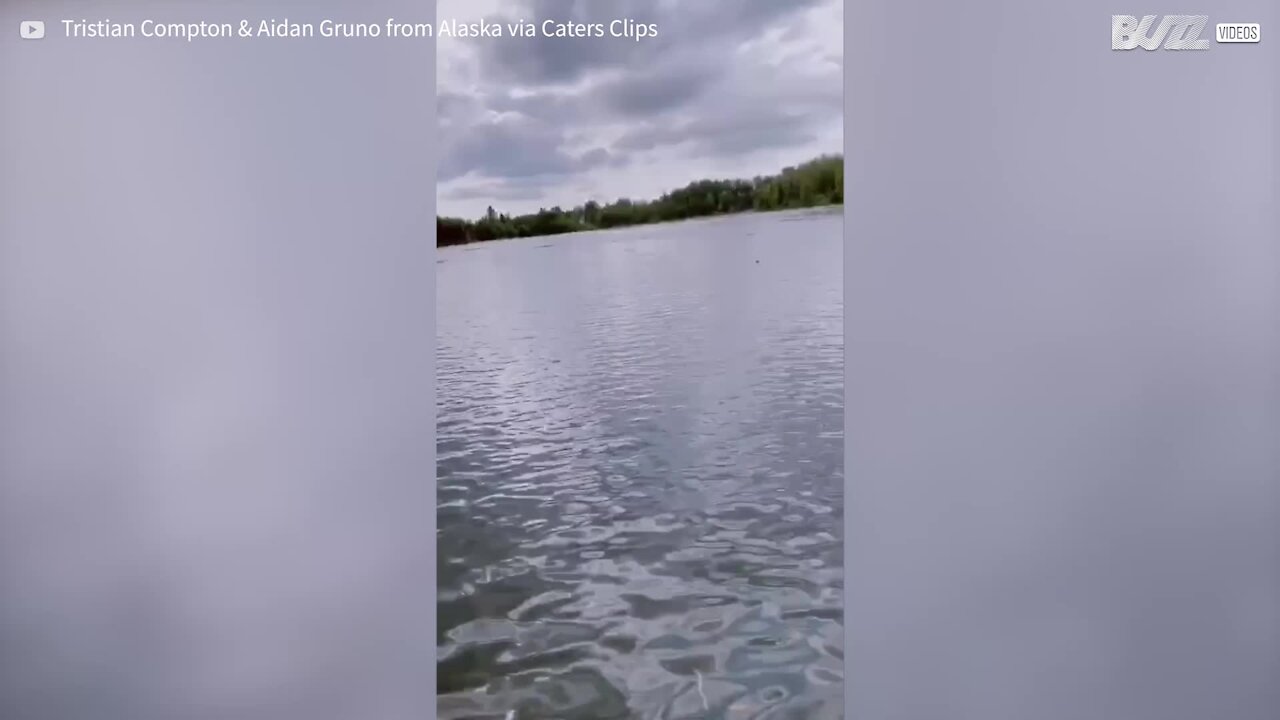 Young man falls into lake and catches fish with bare hands