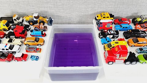 Diecast Model Cars Sliding Into The Purple Water.