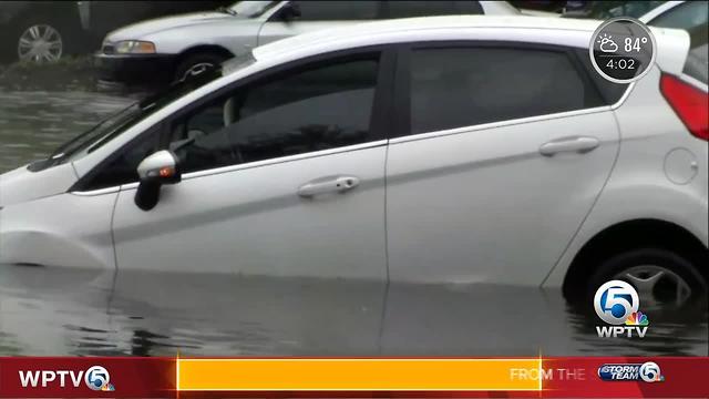 Drivers stall cars on flooded street