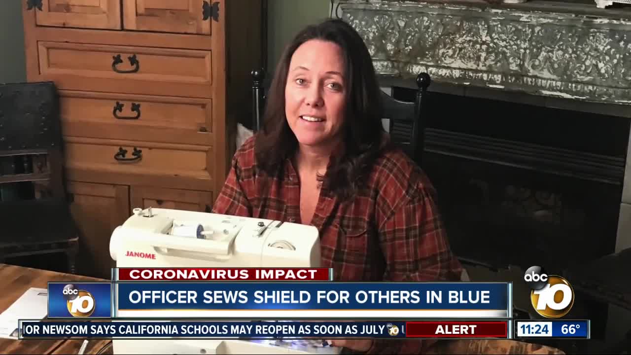 Officer sews shield for others in blue