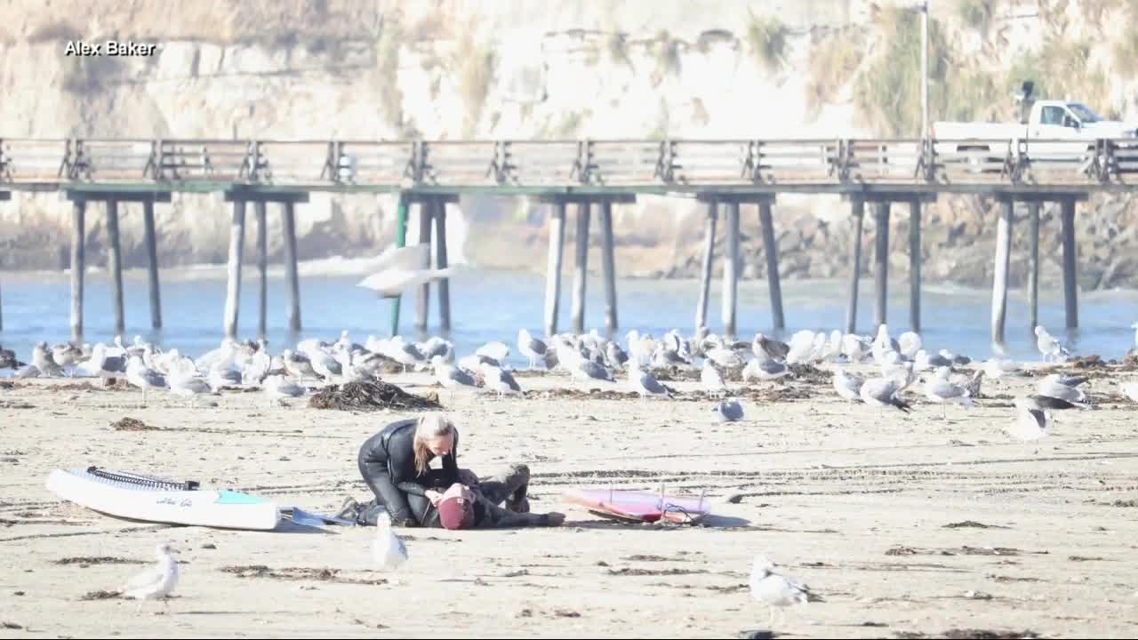 Surfer collapses on beach during first date