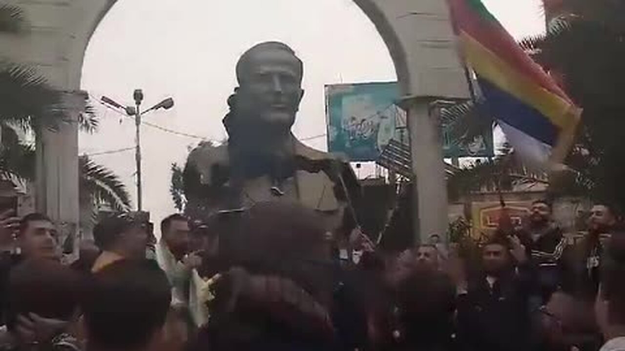 Syrians Topple Hafez al-Assad Statue In Damascus Suburb