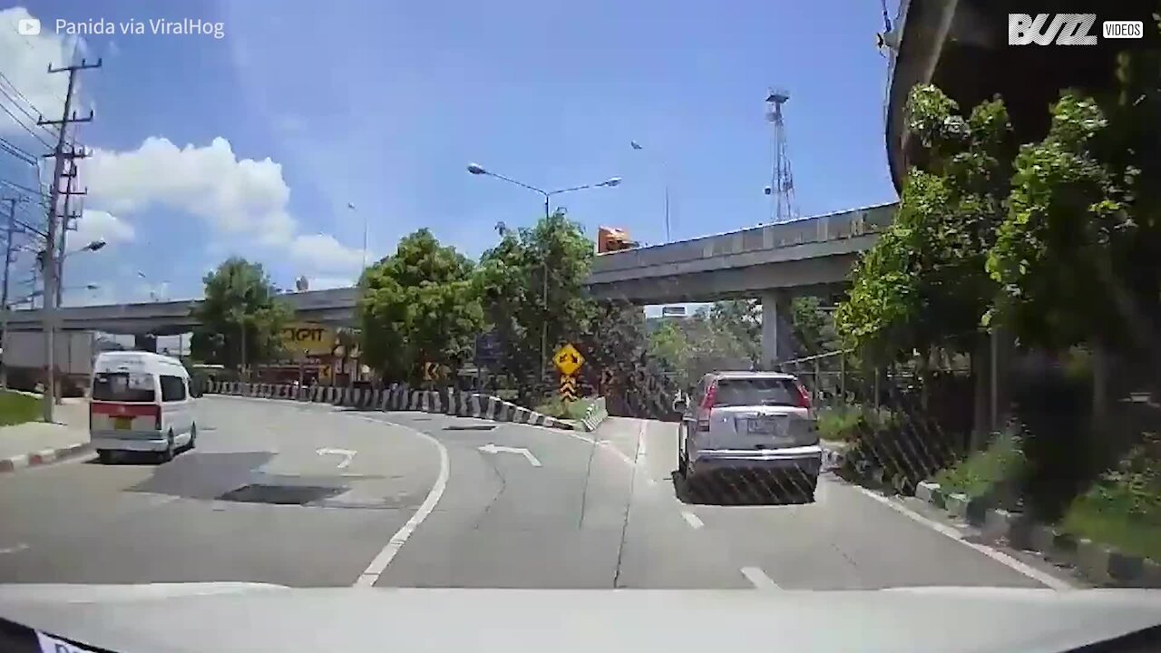Motorcyclist collides with car but rides away unfazed
