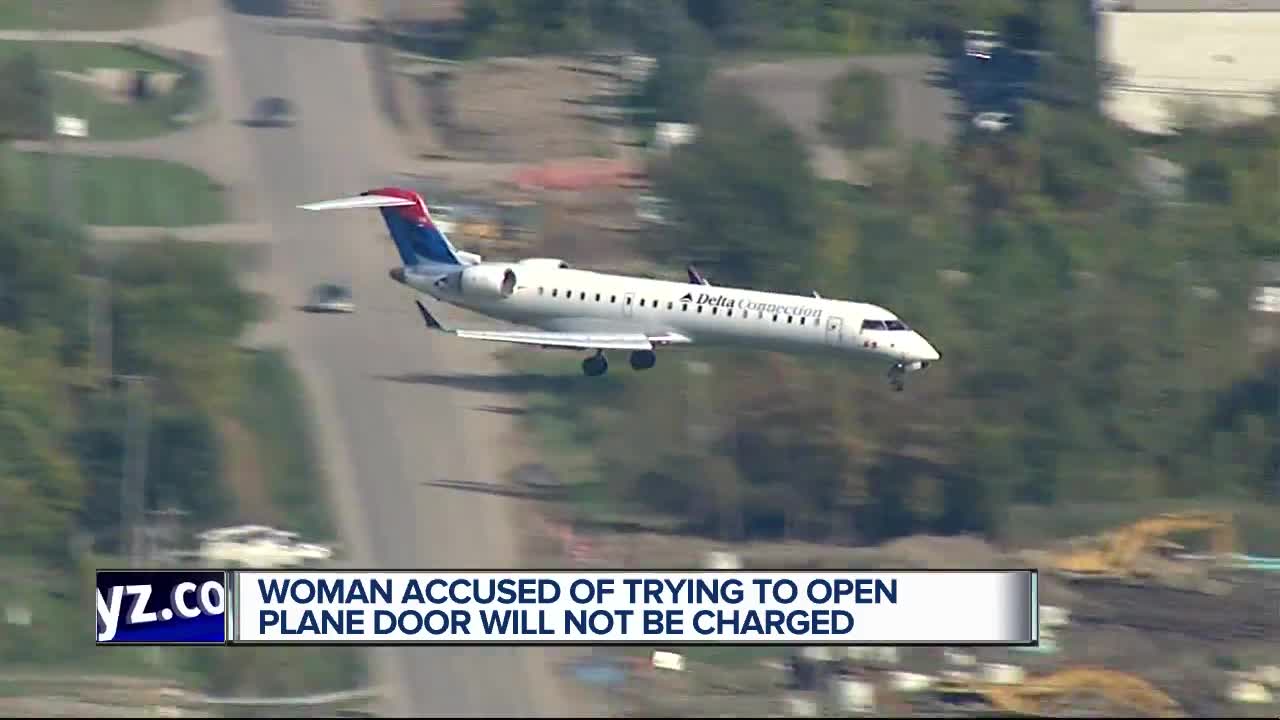 Woman accused of trying to open plane door will not be charged