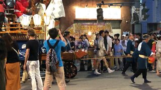 Shrine cart and Traditional dancers at a festival in Japan