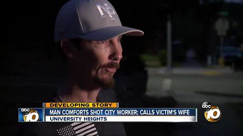 man comforts shot city worker; calls victim's wife