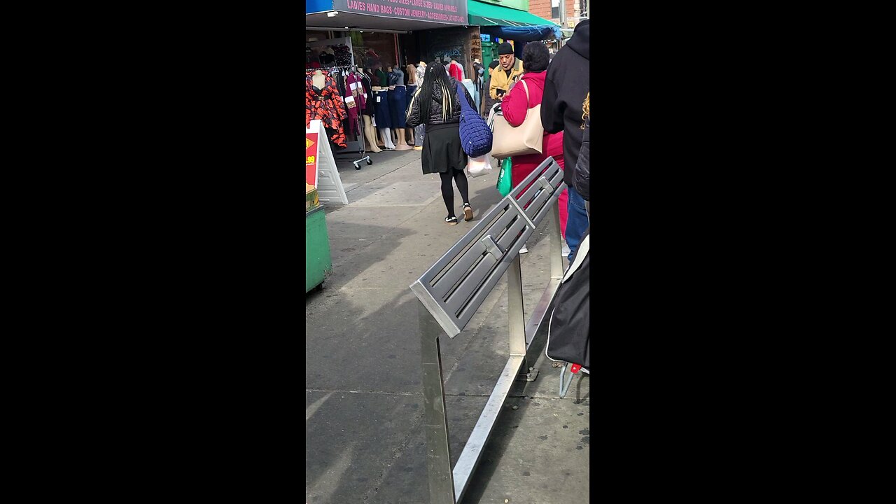 See woman in gray coat doing palm fixation drill as she approached me in beginning of video