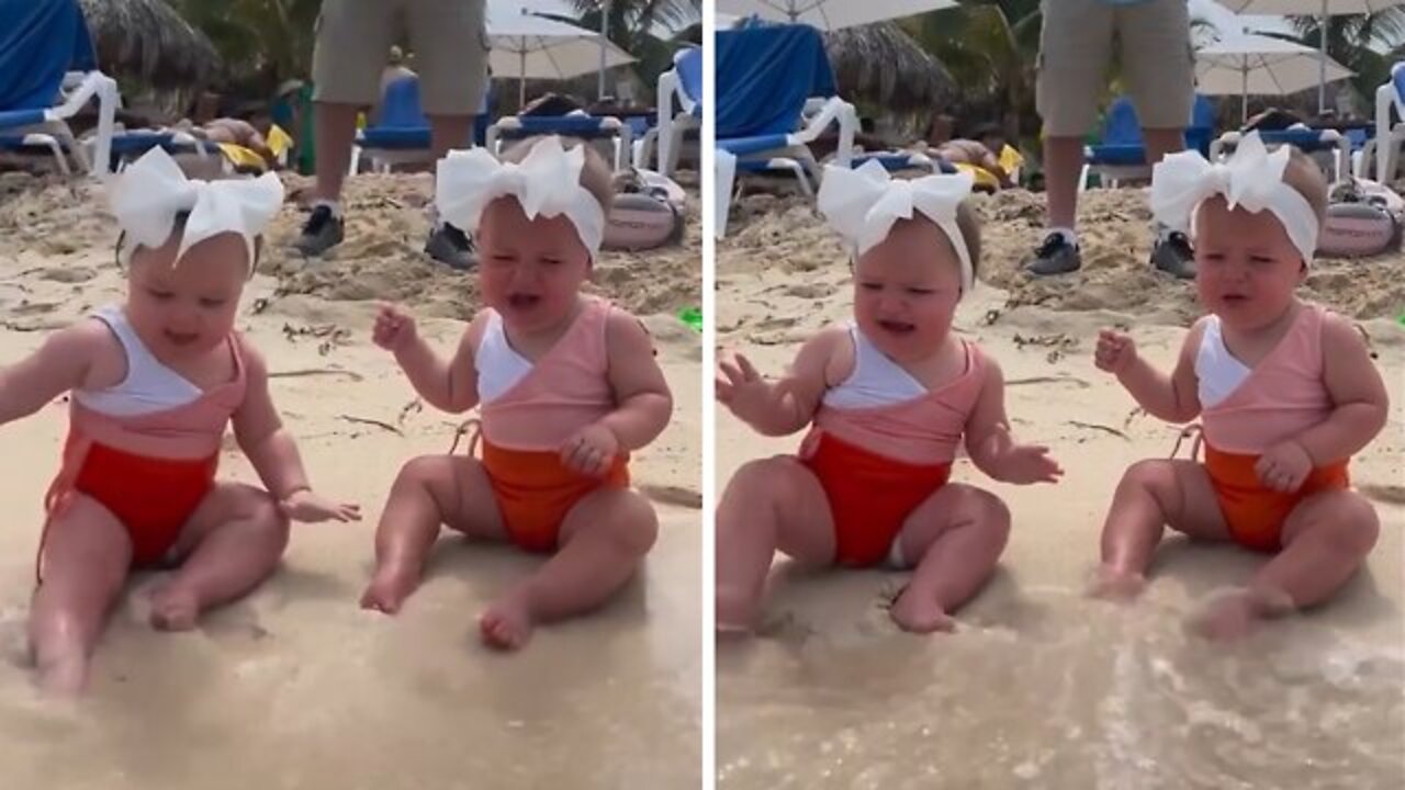 Twin babies adorably confused by ocean waves