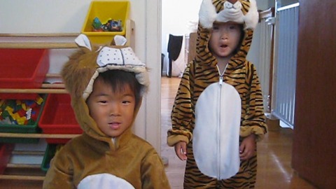 A Brother And Sister Dressed As A Lion And Tiger Roaring and Laughing