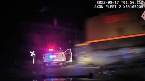 Video shows train hitting police cruiser with suspect inside