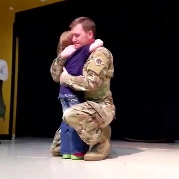 School Stage Becomes A Place Where Sergeant And Daughter Share A Hug