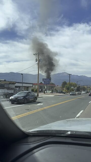 Car burning down in a parking lot