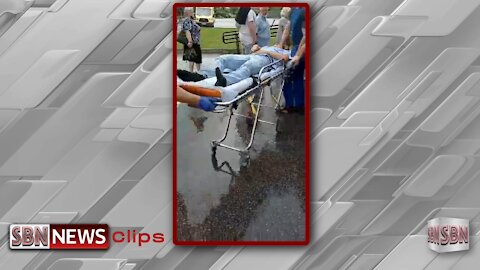 A Man Is Rolled Out By Paramedics Having a Seizure After Receiving the Shot - 2238