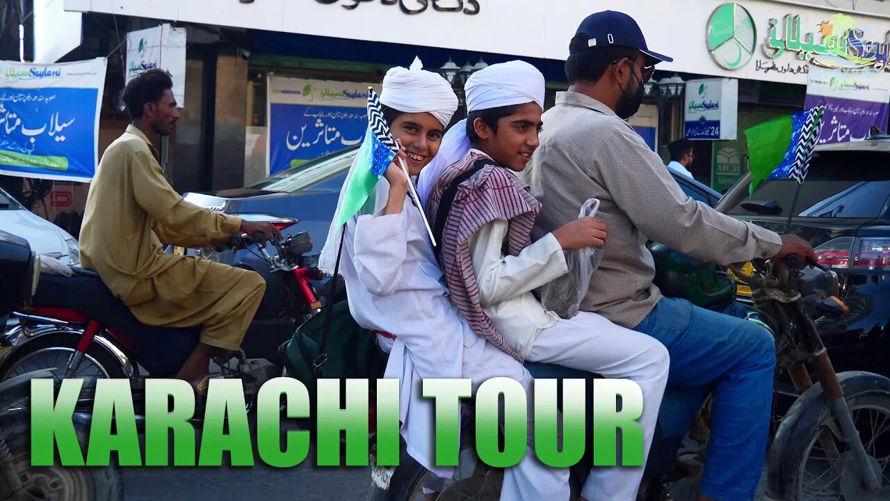 Local Pakistani shows white foreigner the beautiful city of Karachi