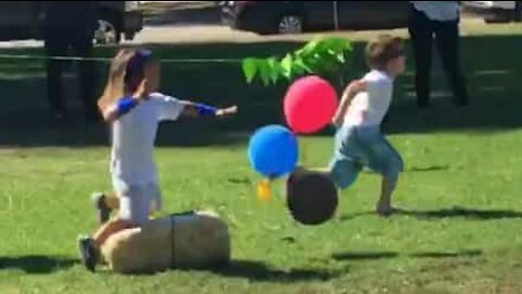 Distracted child trips over hay bale and loses race