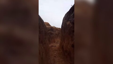 Ukrainian troops taking cover in a trench somewhere on the front lines