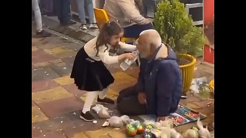The little girl is watering the laborer