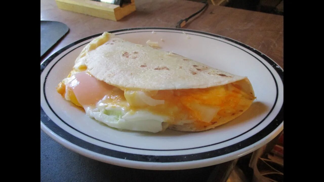 eggs on flower tortilla cheese and onion fast food for less