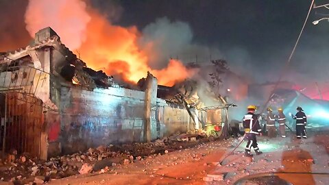 Firefighters tackle a blaze after an explosion in a Dominican shop | AFP