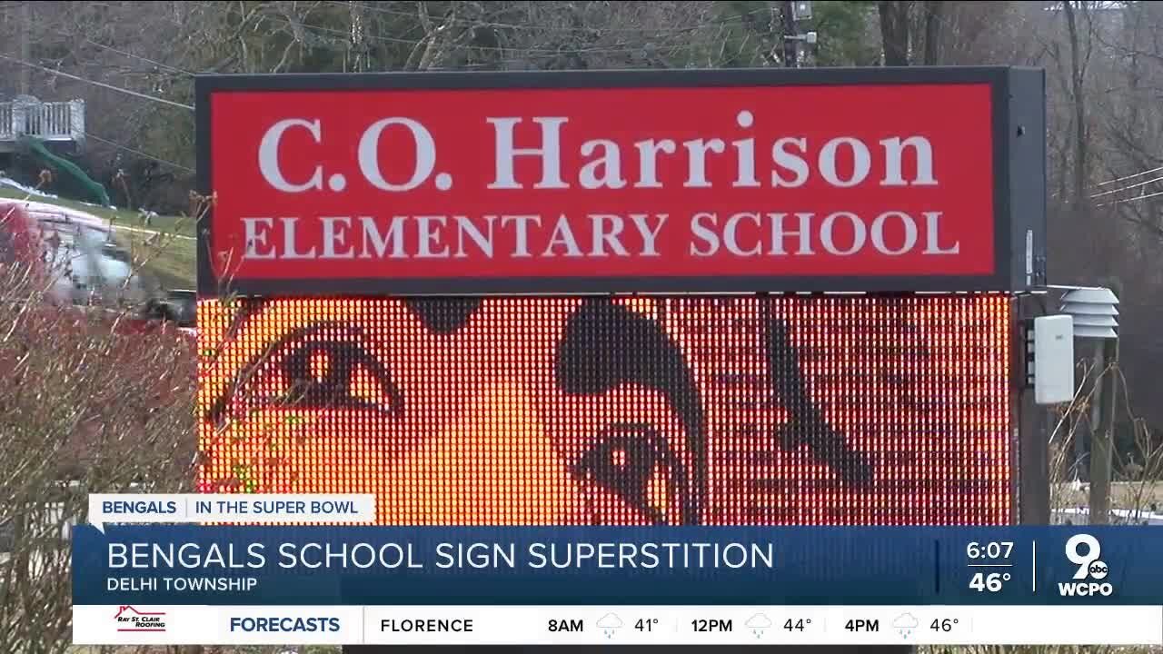 What is the superstition behind the 'Who Dey' sign at C.O. Harrison Elementary School?