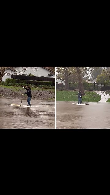 Resident paddleboards through flooded streets of Goleta, CA