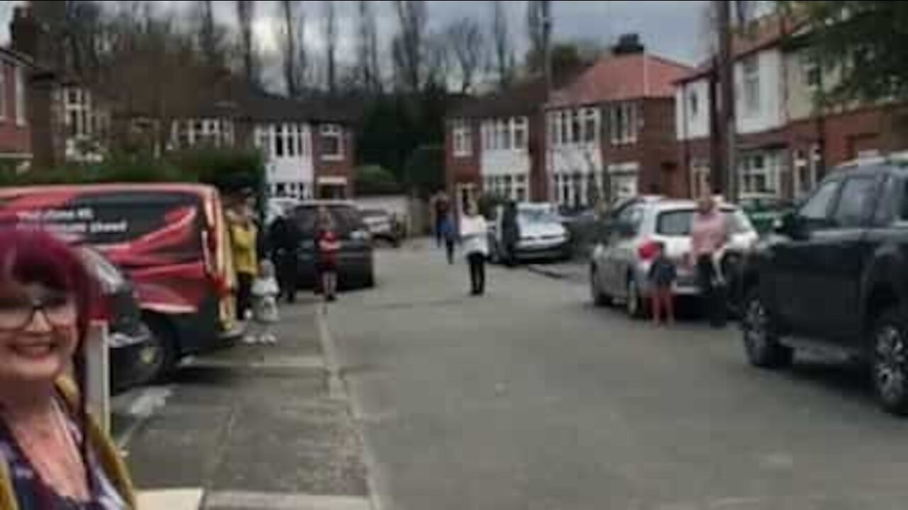 Quarantined neighbors sing happy birthday to teen on the street