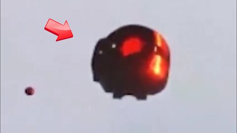 Spherical UFO of red light in the sky above
