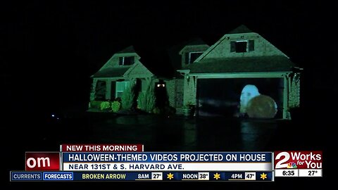 Halloween-themed videos projected on house