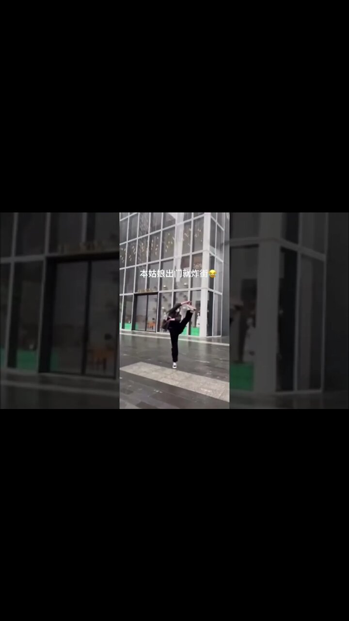 Skinny Chinese Girl Dances On The Street In The Rain