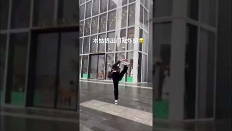 Skinny Chinese Girl Dances On The Street In The Rain