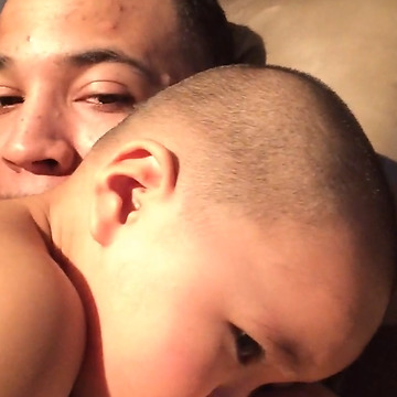 A Baby Boy Hugs And Kisses His Dad Who Is Making A Howling Or Crying Noise