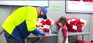 Little boy puts together thank you bags for sanitation workers