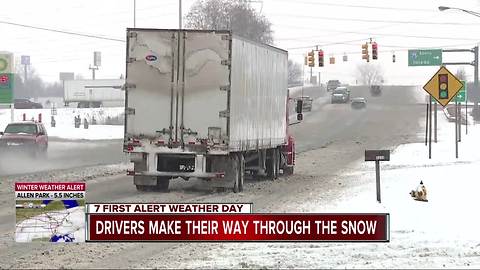 Drivers make their way through the snow