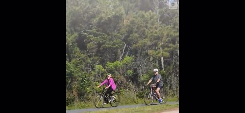 Biden falls off the bike